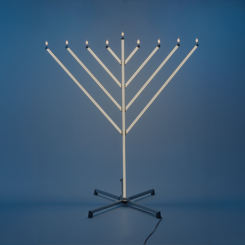 Menorah with lit candles on a blue background