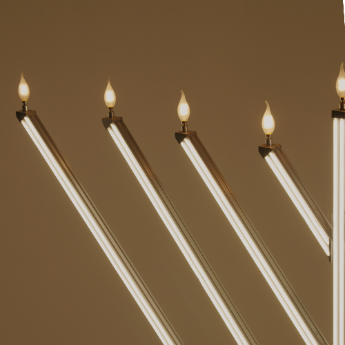 Menorah with lit candles against a brown background